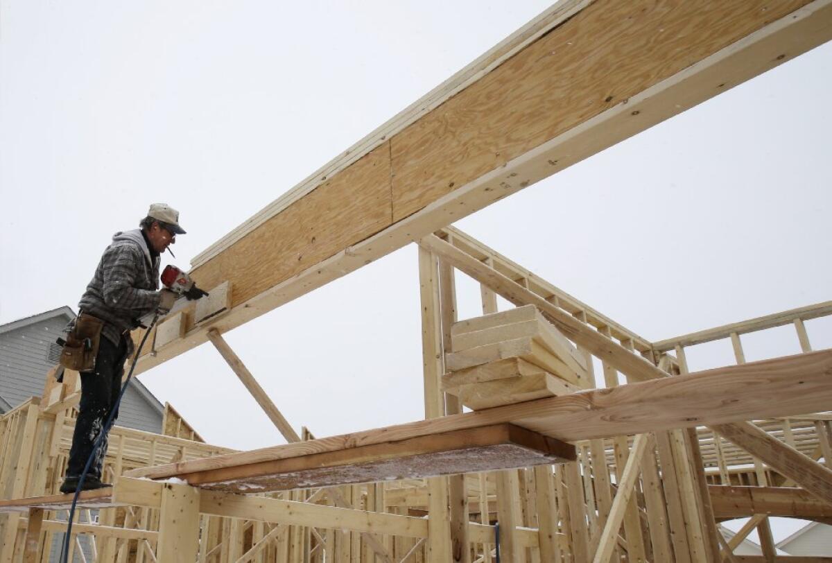 Mortgage rates rose slightly this week on mixed economic news, home finance giant Freddie Mac said. Above, home construction in Pepper Pike, Ohio.