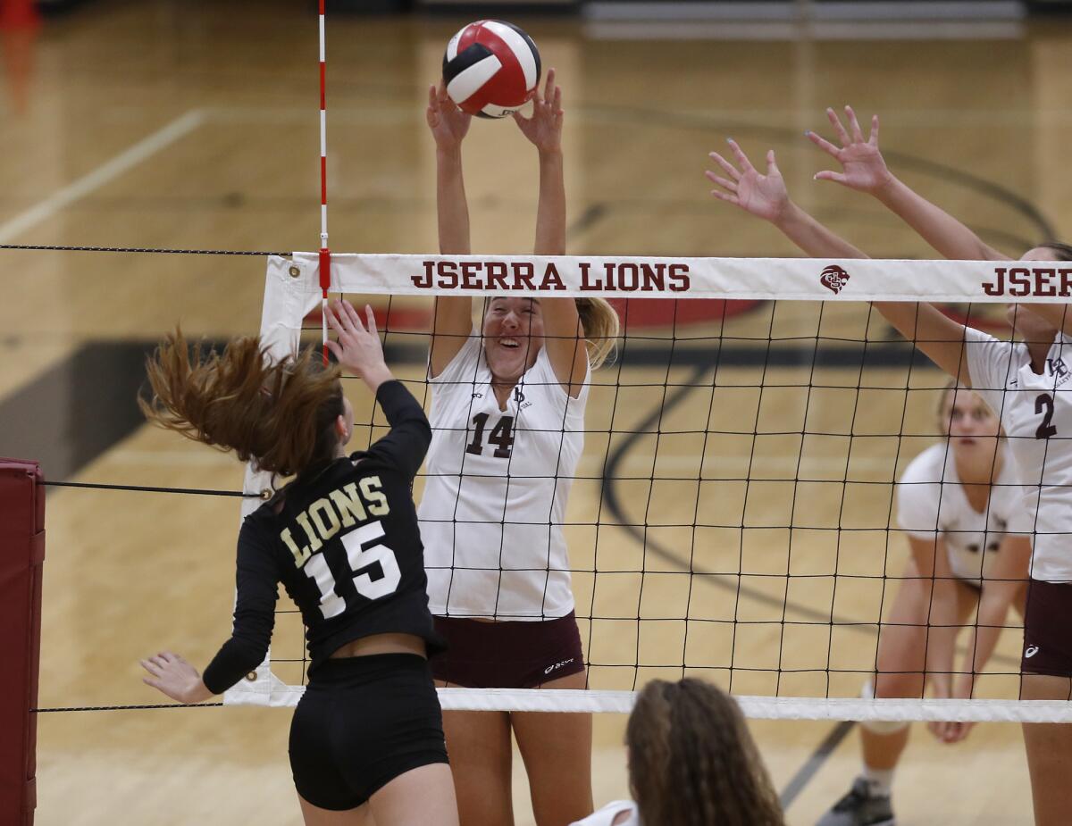 Laguna Beach's Piper Naess (14) defends as JSerra's Melissa Foley (15) is called for a net violation in the first set of a nonleague match on the road Wednesday.