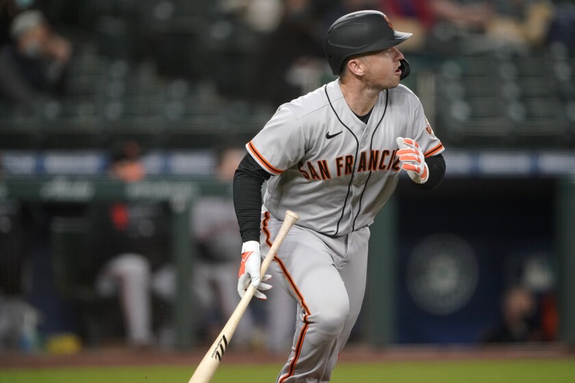 San Francisco Giants' Buster Posey watches his solo home run during the third inning of the team's baseball game against the Seattle Mariners, Friday, April 2, 2021, in Seattle. (AP Photo/Ted S. Warren)