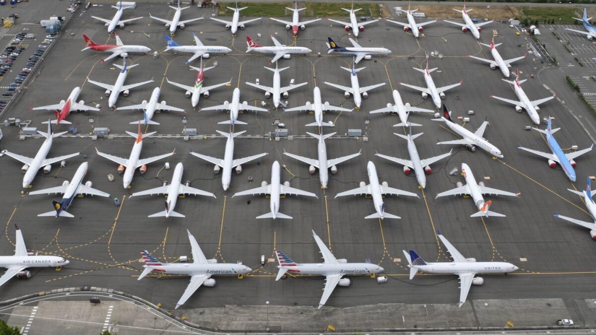 Boeing 737 Max airplanes are stored near Boeing Field in Seattle. The planes have been grounded since March.