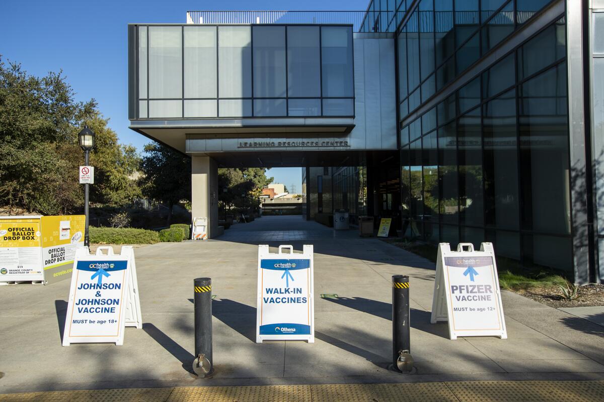 Signs on the campus of Golden West College direct people to a COVID-19 vaccine clinic on Wednesday.