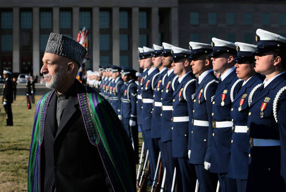 Afghan President Hamid Karzai reviews an honor guard during a ceremony welcoming him to the Pentagon in Washington.
