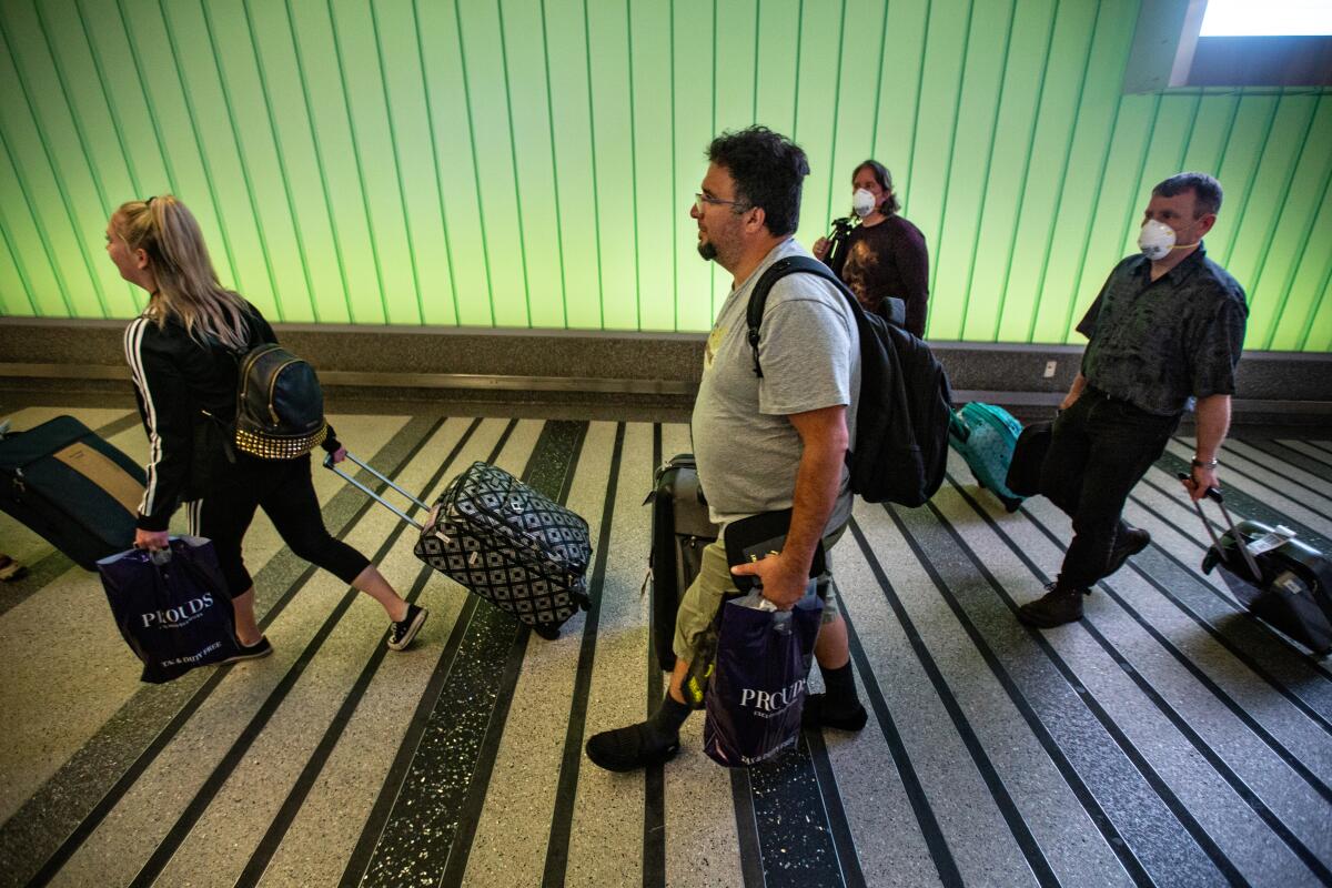 Travelers returning from international trips pass through LAX