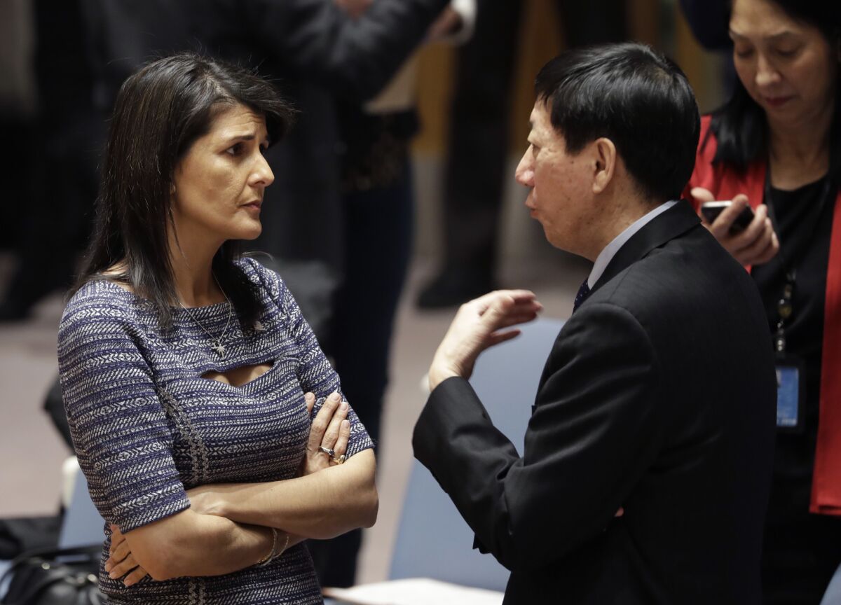 Then-U.S. Ambassador Nikki Haley talks with Chinese diplomat Wu Haitao in December 2017 at United Nations headquarters, where the Security Council voted to impose additional sanctions on North Korea, including sharply lower limits on its oil imports.