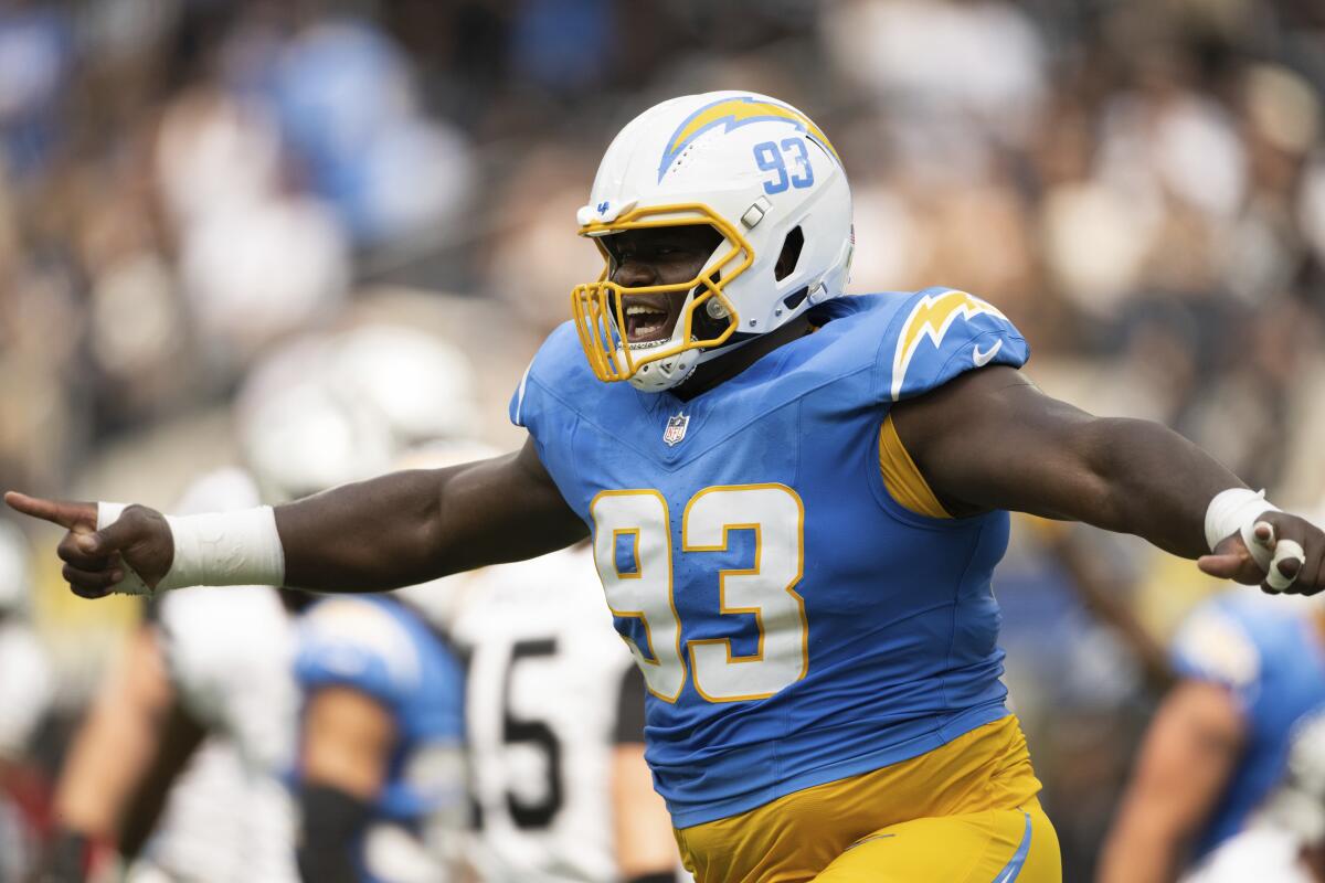  Chargers defensive tackle Otito Ogbonnia (93) reacts after a big defensive play.