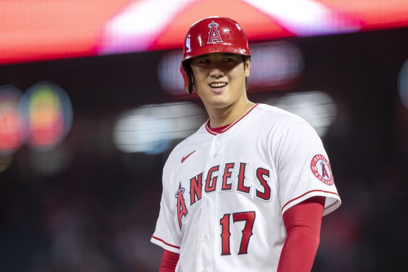 Los Angeles Angels designated hitter Shohei Ohtani smiles while at third base during the first inning of the team's baseball game against the Texas Rangers in Anaheim, Calif., Friday, Sept. 30, 2022. (AP Photo/Alex Gallardo)