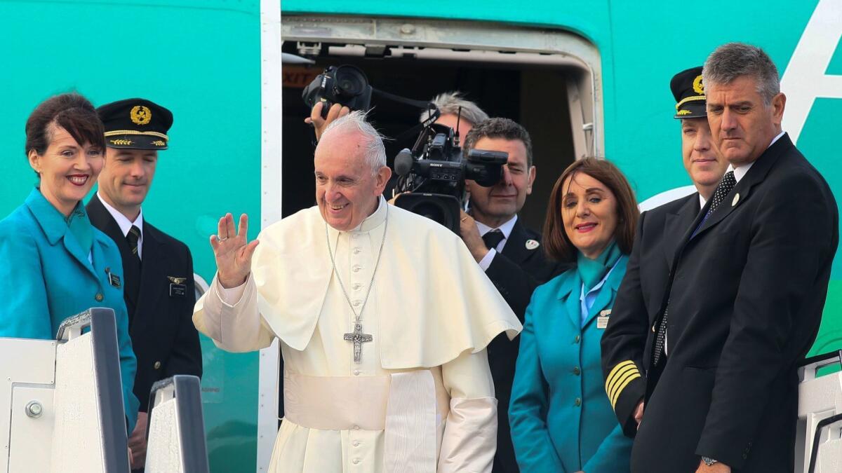 Pope Francis waves during a farewell ceremony at Dublin Airport before leaving Ireland on Aug. 26.