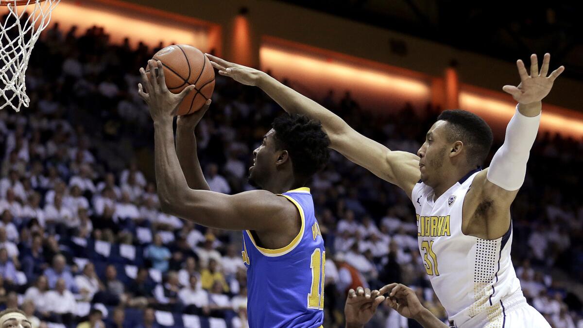 UCLA guard Isaac Hamilton gets past California guard Stephen Domingo for a layup in the first half Thursday night.