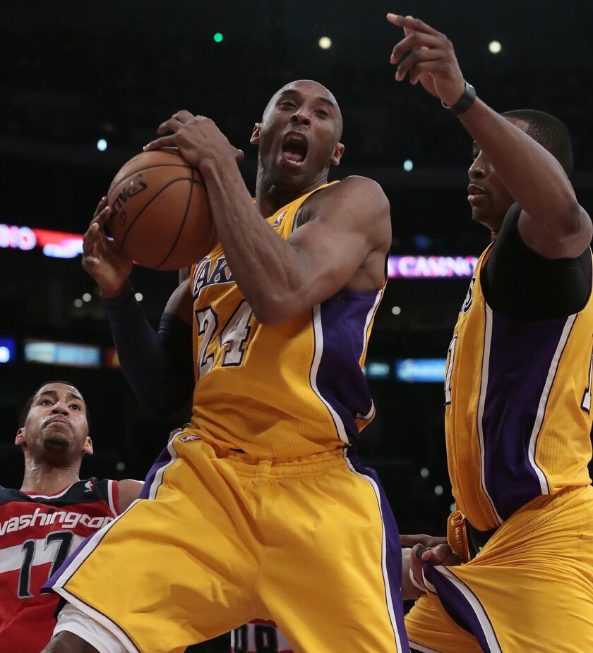 Lakers star Kobe Bryant, center, in action.