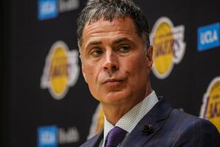 Lakers general manager Rob Pelinka watches as new head coach JJ Redick talks with the media on June 24