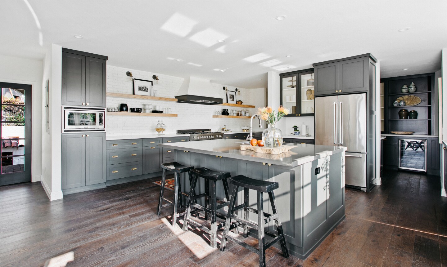 Built in 1931, the three-story home with an elevator features a chic courtyard entry and a landscaped backyard with a swimming pool.