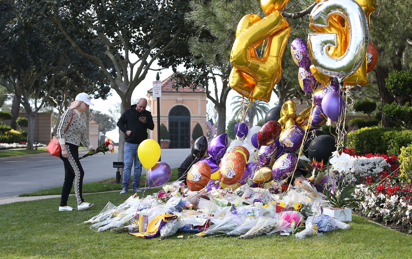 People arrive outside the gated community of Pelican Crest community to pay their respects to Kobe Bryant where he lived with his family in Newport Coast.