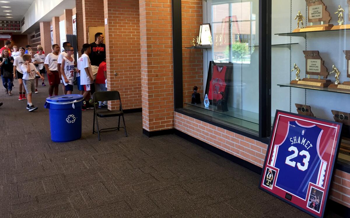 Landry Shamet's framed Clippers jersey sits in front of the Park Hill High trophy case as kids file into the gym for his basketball camp.