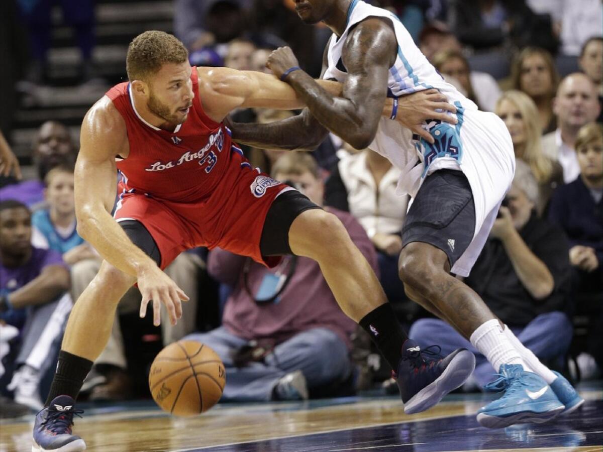 Blake Griffin drives against Charlotte forward Marvin Williams during the first half of the Clippers' 113-92 win over the Hornets on Nov. 24.