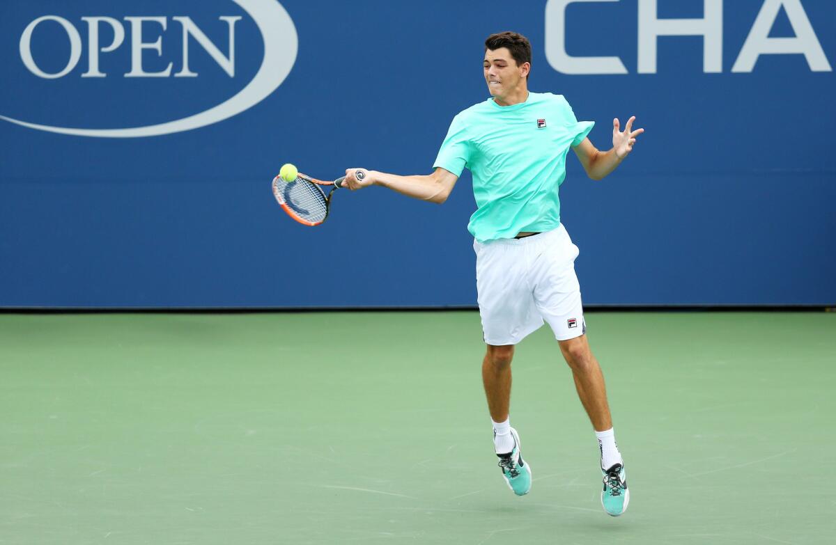 Taylor Fritz returns a shot to Tommy Paul during the 2015 U.S. Open boys' final.