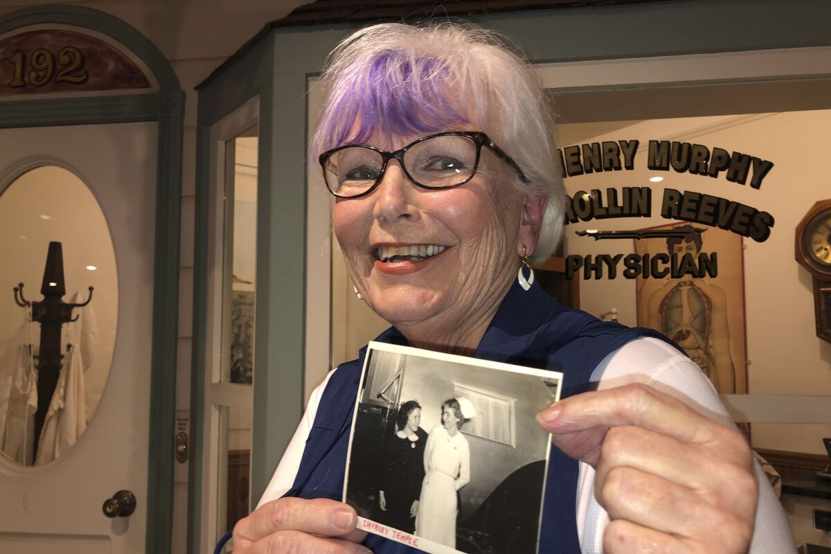 Sigrid Stokes with photograph of her mother