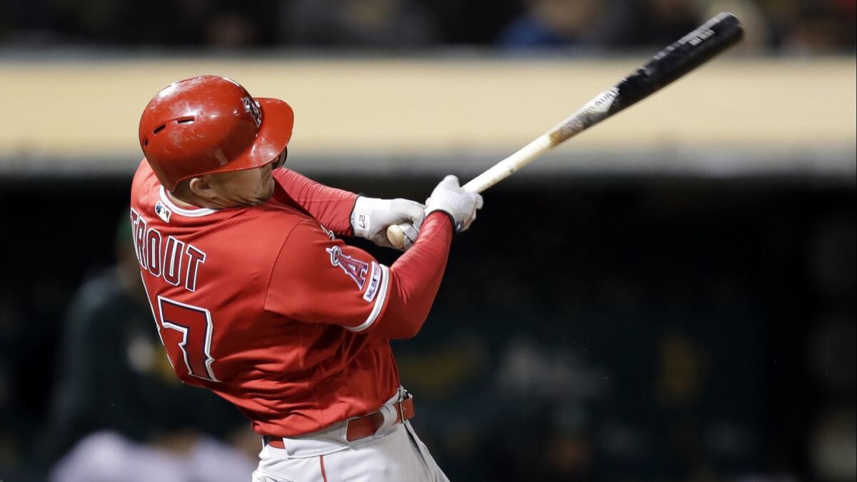 Angels center fielder Mike Trout follows through on a single during the sixth inning of a 6-2 win over the Oakland Athletics on Friday.