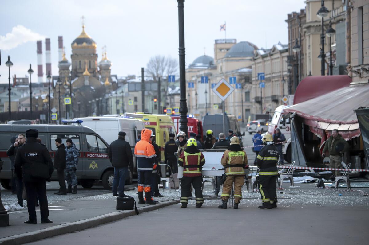 Emergency personnel outside Russian cafe where a bomb went off