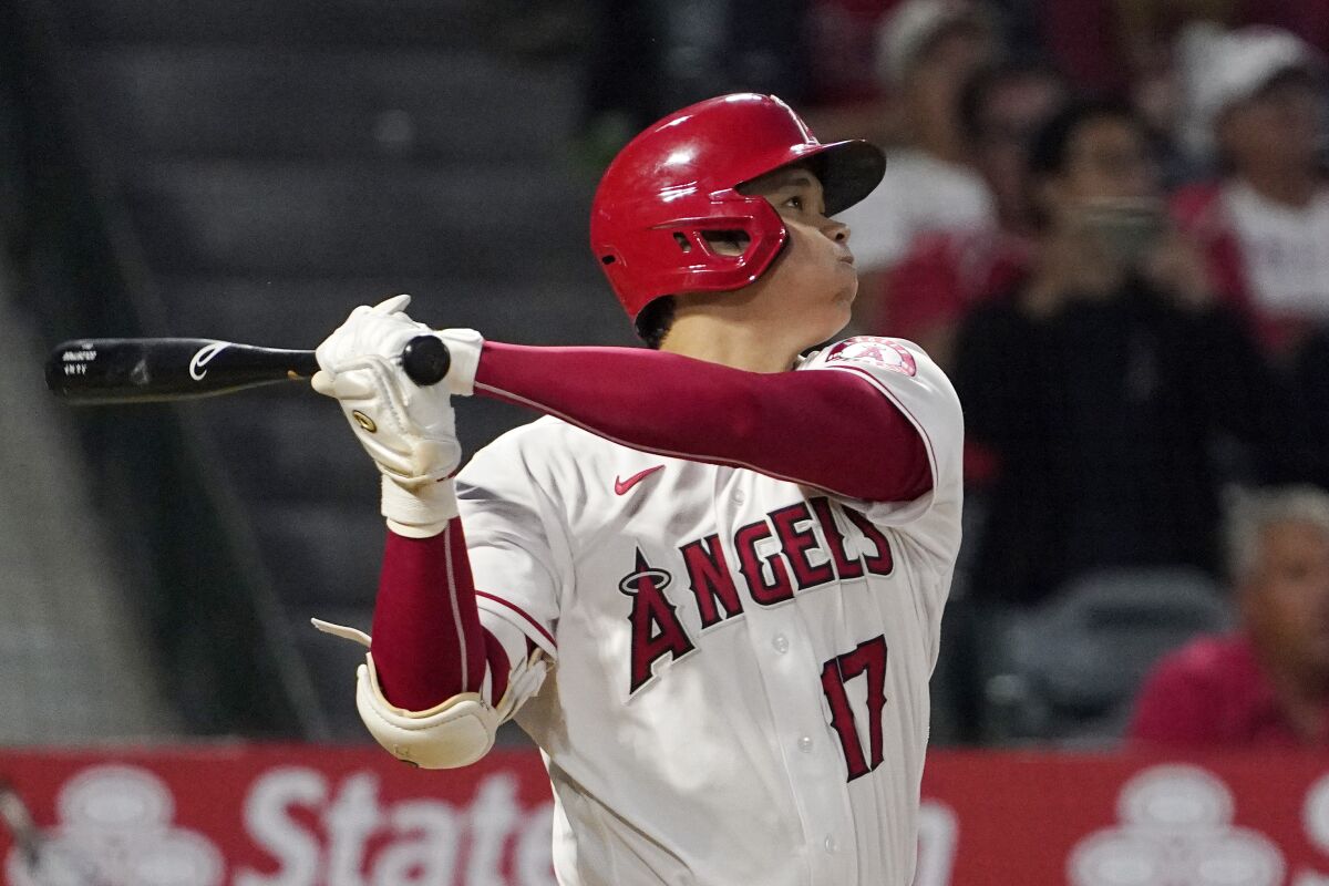 Los Angeles Angels' Shohei Ohtani follows through as he hits a two-run home run during the fifth inning of a baseball game against the Boston Red Sox Thursday, June 9, 2022, in Anaheim, Calif. (AP Photo/Mark J. Terrill)