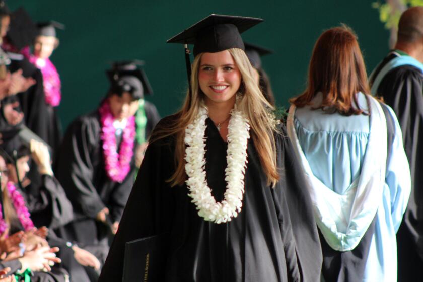 Valedictorian Alexandra Gomez of Newport Coast walks proudly after receiving her diploma.