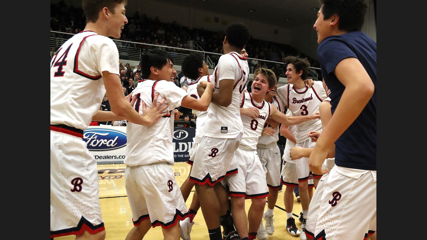 The Brentwood Eagles celebrate their 48-41 win over Crossroads Roadrunners in the Southern Section 2AA championship at the Felix Events Center on Saturday in Azusa.