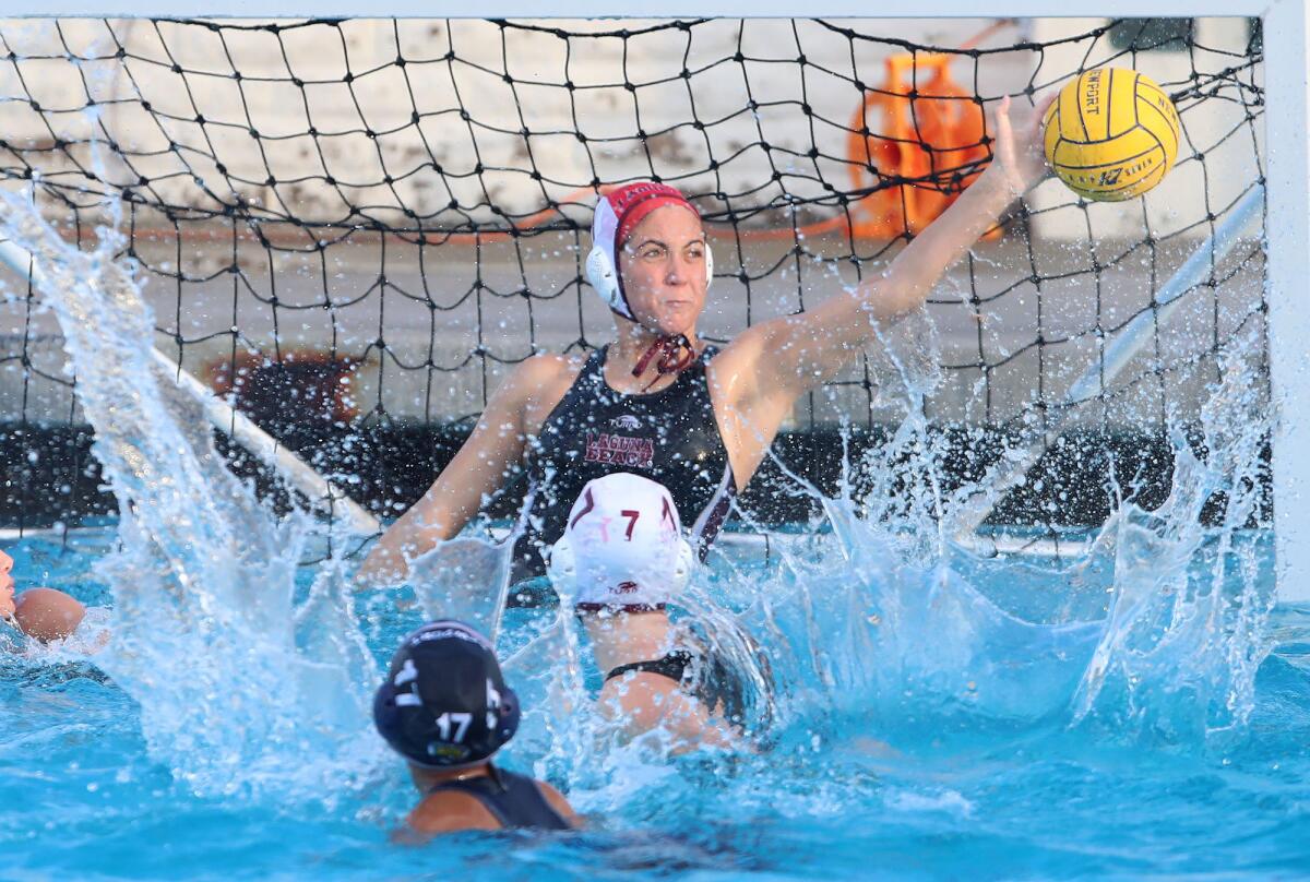 Laguna Beach goalie Siena Jumani reaches for a save during Tuesday's Surf League girls' water polo match.