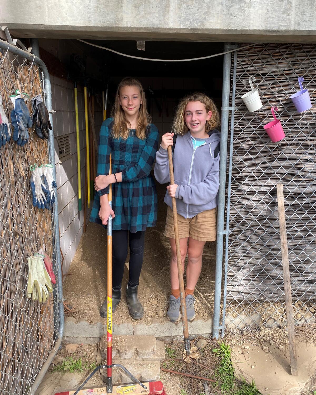 Sixth grader Myah Sturdevant and seventh grader Amelia Riley prepping the storage area.