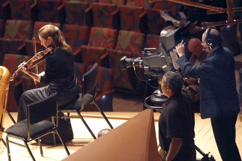Sunday saw the first of the Los Angeles Philharmonic's LA Phil Live theater-casts to movie theaters across the U.S. and Canada. Attendees were given access to the concert, as well as backstage preparations and more. A member of the Philharmonic warms up inside Walt Disney Concert Hall while a camera watches.