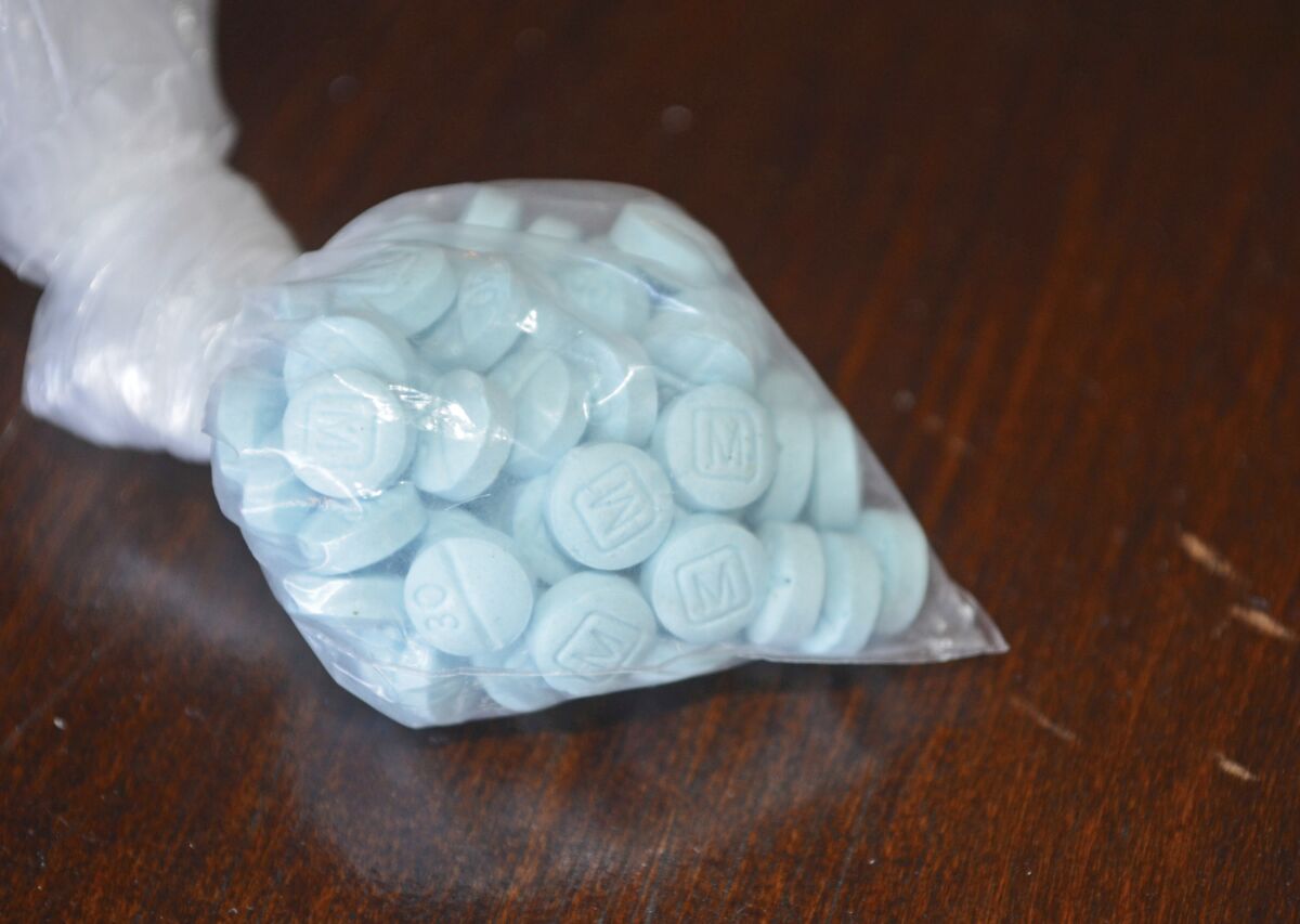 Sky-blue pills in a clear plastic bag