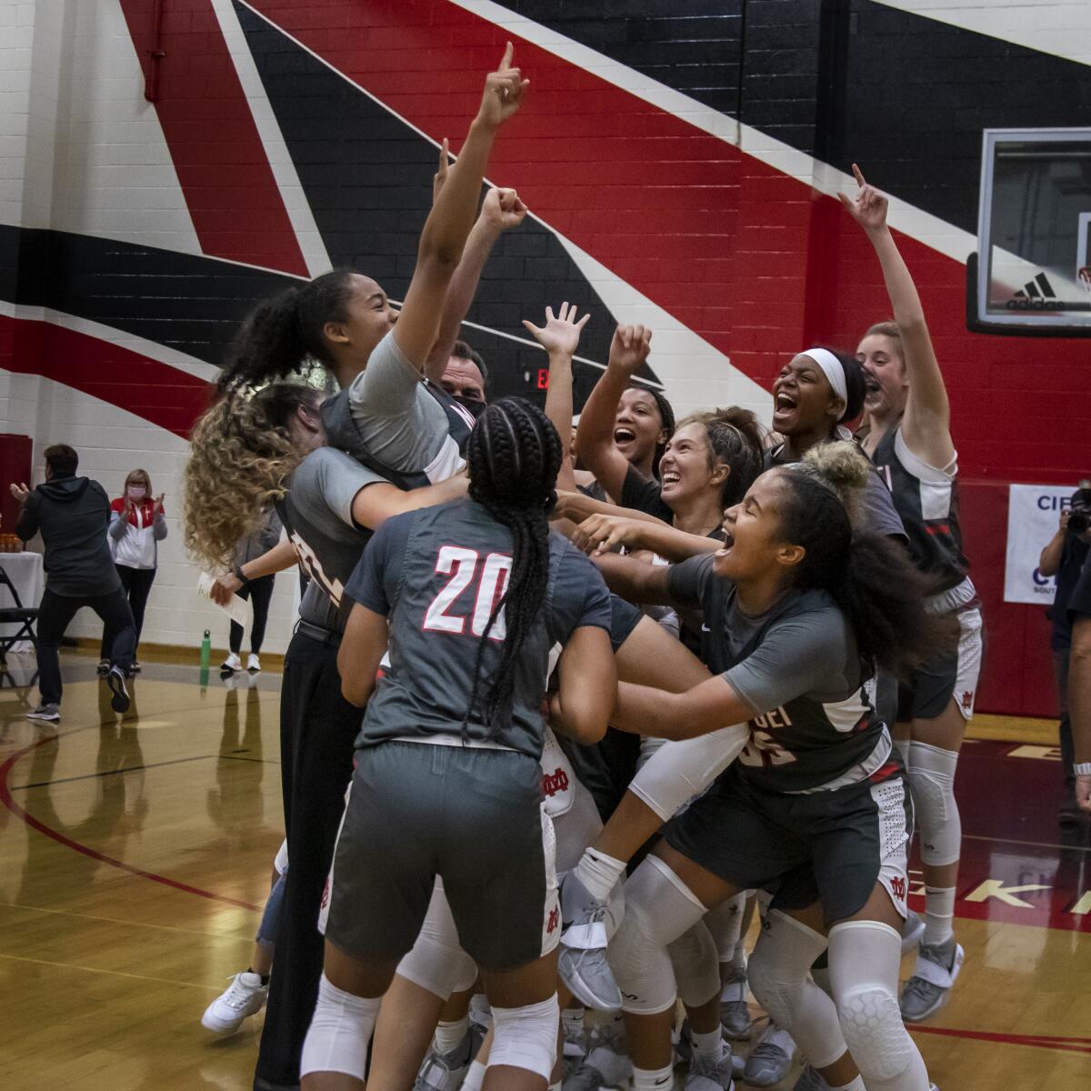 Mater Dei teammates lift up Nalani White after White scored the game-winning shot.