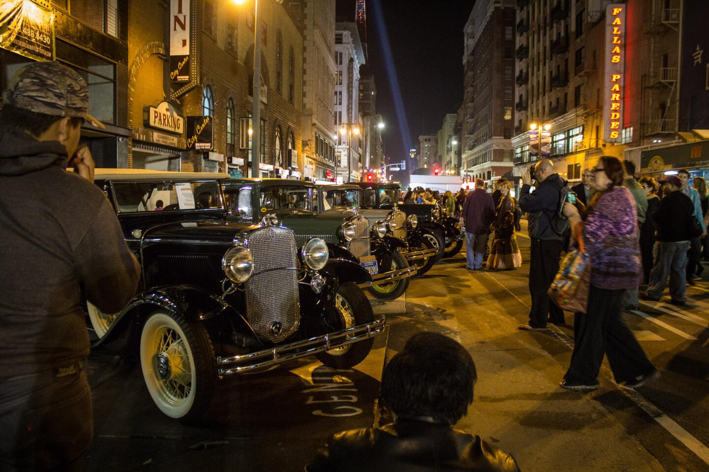 Cars, including a 1931 Chevy Phaeton, left, are on display along Broadway in downtown L.A.