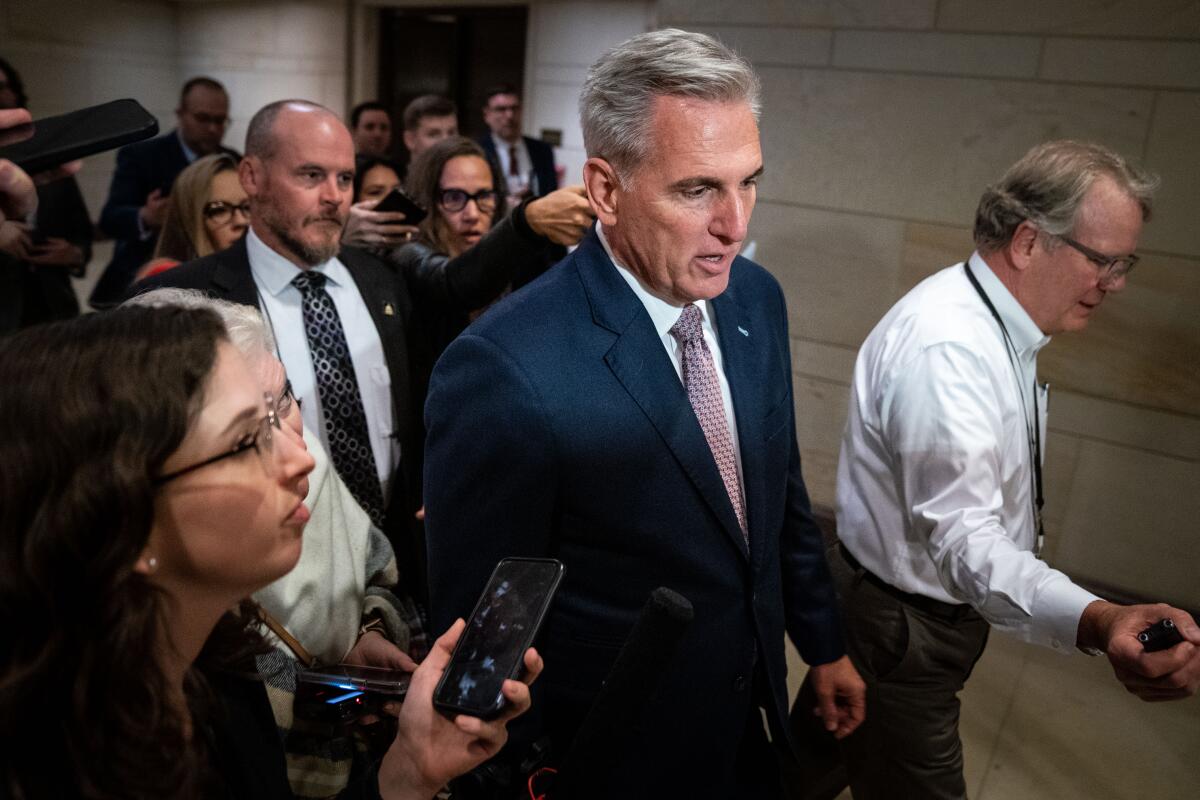 House Minority Leader Kevin McCarthy walks down a hall.