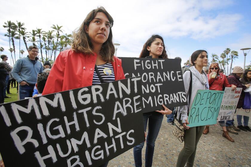 Top left: Francisca Verduzco, left, and her sister, Itzel Verduzco, center, hold signs supporting immigrant rights while attending March in Solidarity with Immigrants, San Diego. Top right: Kyle Fox, 4, and his father, Brady Fox, hold a sign at a vigil held to support the victims of the Chabad of Poway synagogue shooting. Bottom right: Emily Jones, right, and her daughters Tyra Neptune-Lucas, 12, second from right, and Lyssa Ballard, 16, center, hold signs on Espola Road to show support for Chabad of Poway. Bottom left: Kamri Jackson, center, holds up a sign as she and other people protest the Supreme Court’s decision to uphold Donald Trump's travel ban while in front of the Edward J. Schwartz Federal Building in San Diego.