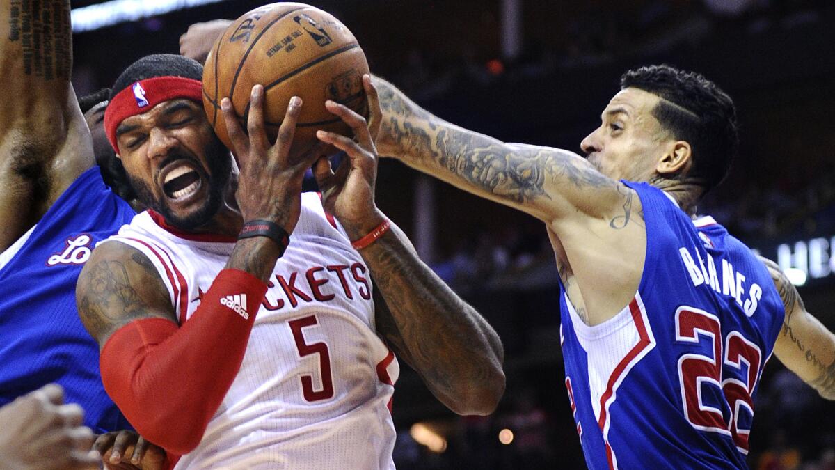 Clippers small forward Matt Barnes, right, blocks a shot by Houston Rockets forward Josh Smith during the Clippers' 117-101 victory in Game 1 of the Western Conference semifinals in Houston on May 4.