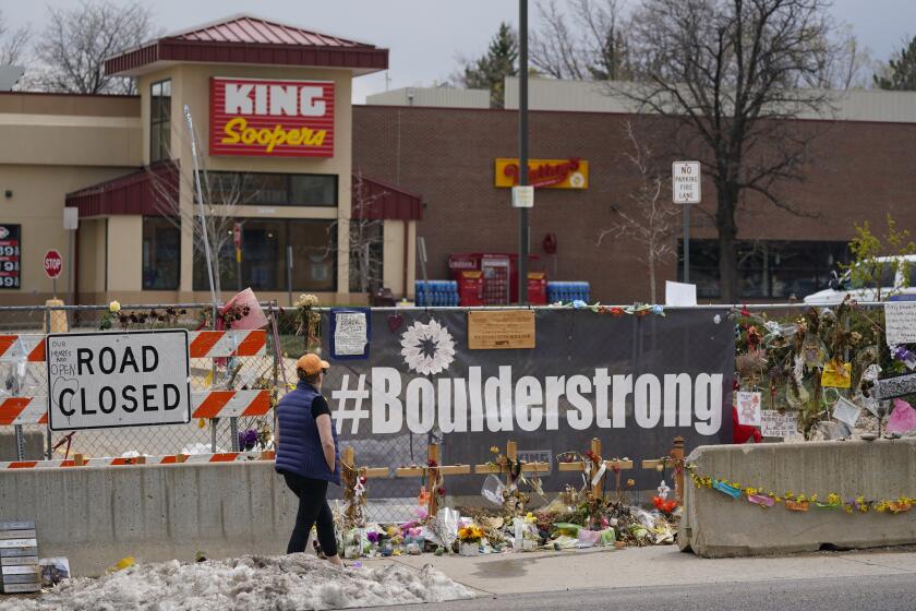 FILE - Tributes cover the temporary fence around the King Soopers grocery store in which 10 people died in a mass shooting in late March on Friday, April 23, 2021, in Boulder, Colo. (AP Photo/David Zalubowski, File)