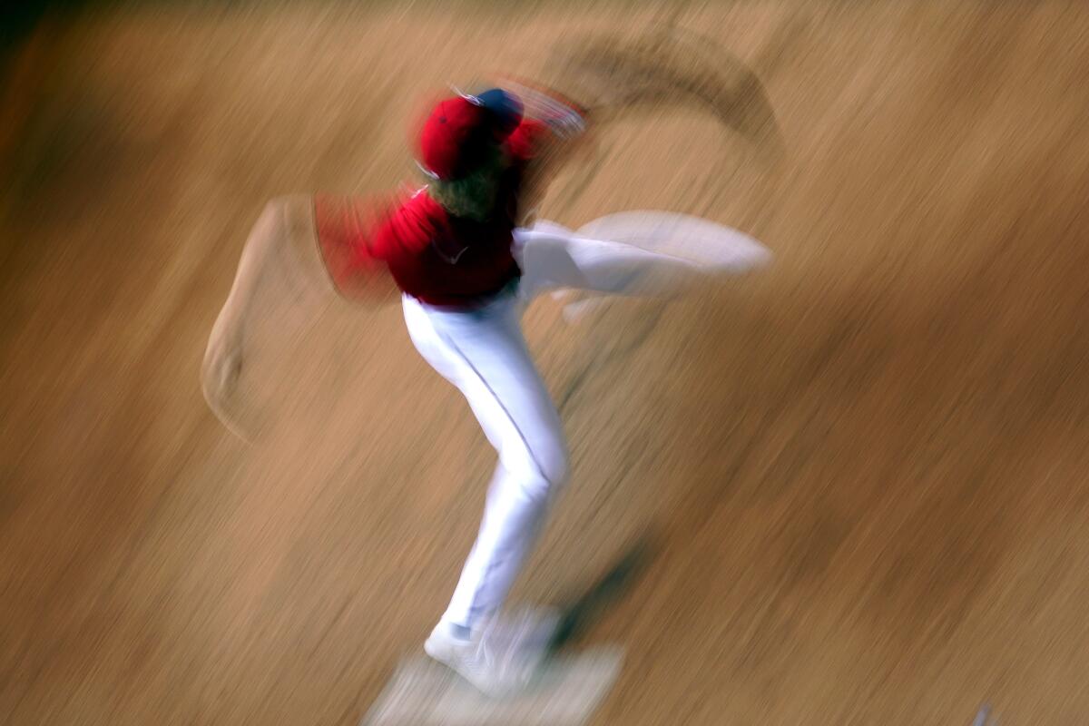In this image taken with a slow shutter speed, Minnesota Twins starting pitcher Joe Ryan warms up in the bullpen before a baseball game against the Detroit Tigers Wednesday, Aug. 3, 2022, in Minneapolis. (AP Photo/Abbie Parr)