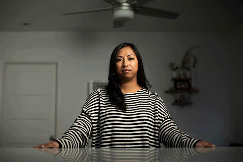 An animated gif of a woman in a black and white striped shirt