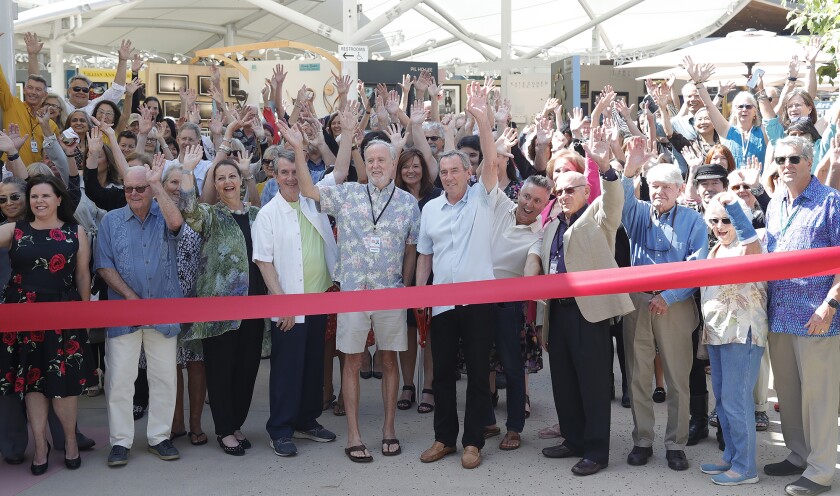 Festival of Arts president David Perry and Mayor Bob Whalen, center, from left, stand with cheering artists.