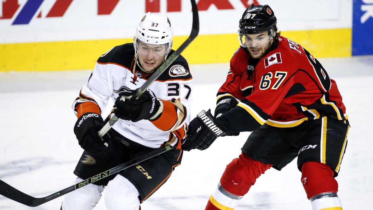 Ducks winger Nick Ritchie (37) skates past Flames winger Michael Frolik during a game earlier this season.