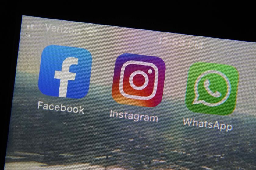 This photo shows the mobile phone app logos for, from left, Facebook, Instagram and WhatsApp in New York, Tuesday, Oct. 5, 2021. The six-hour outage was a headache for many casual users but far more serious for the millions of people worldwide who rely on the social media sites to run their businesses or communicate with relatives, fellow parents, teachers or neighbors. (AP Photo/Richard Drew)