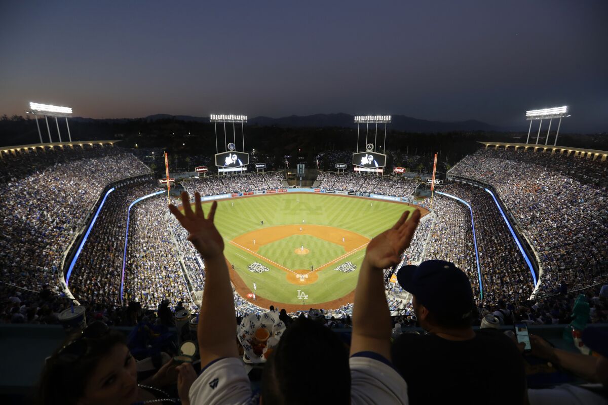 Dodgers fans wave souvenir towels as they cheer on the Dodgers during Game 2 of the 2017 World Series.