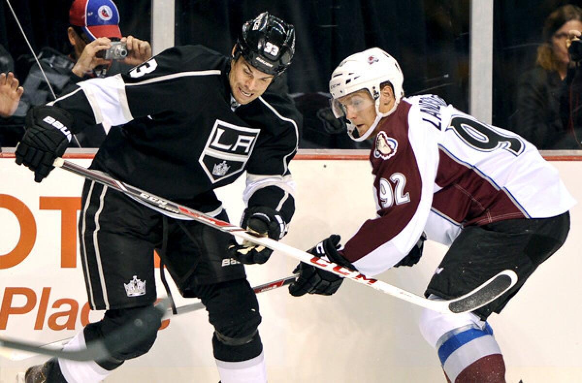 Kings defenseman Willie Mitchell, left, battles Avalanche left wing Gabriel Landeskog for the puck during a preseason game.