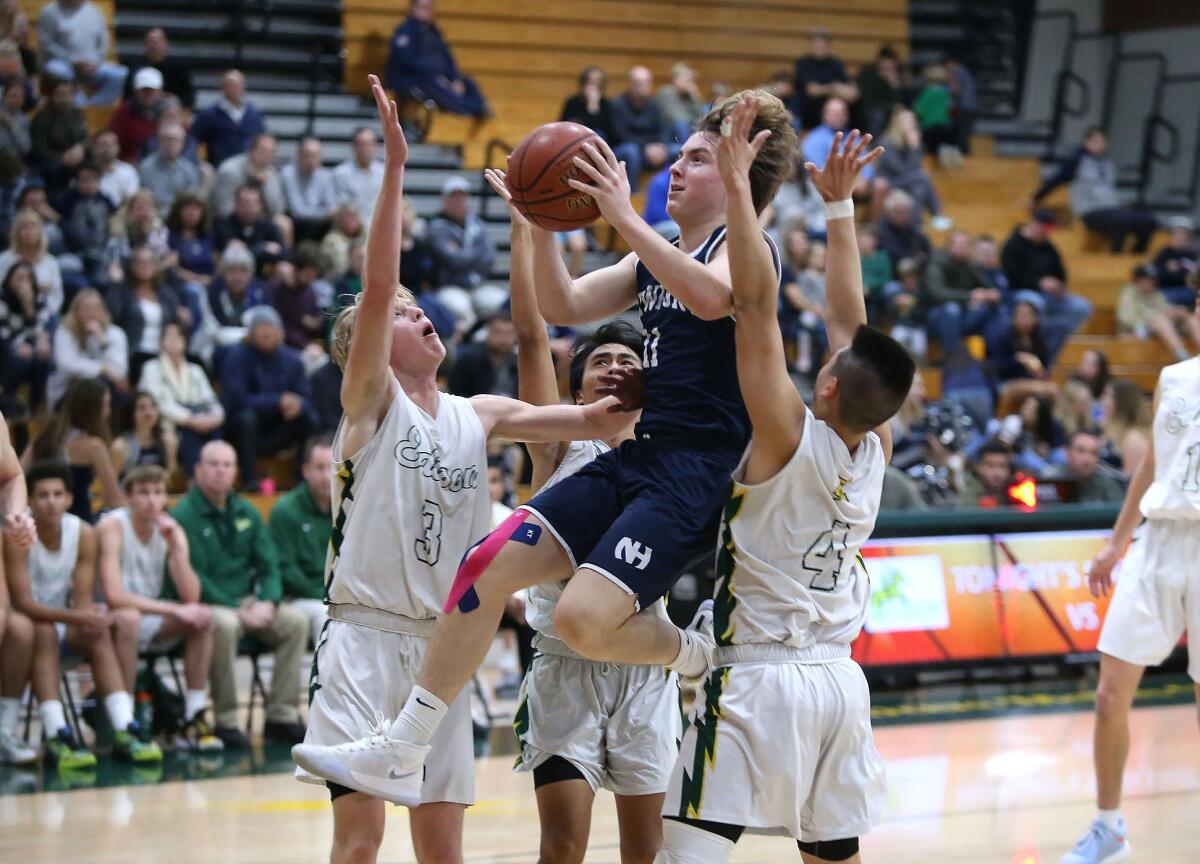 Newport Harbor’s Levi Darrow, shown driving against Edison in 2020, had 22 points for the Sailors in their win.