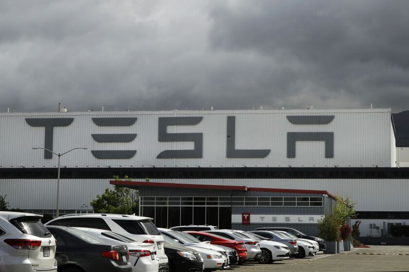 This photo shows the Tesla plant Tuesday, May 12, 2020, in Fremont, Calif. Tesla CEO Elon Musk has emerged as a champion of defying stay-home orders intended to stop the coronavirus from spreading. He reopened Tesla's San Francisco Bay Area factory on Monday and President Donald Trump is supporting that decision. (AP Photo/Ben Margot)