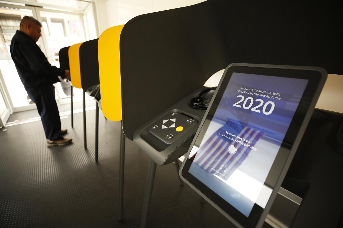 A voter fills out his ballot electronically. 