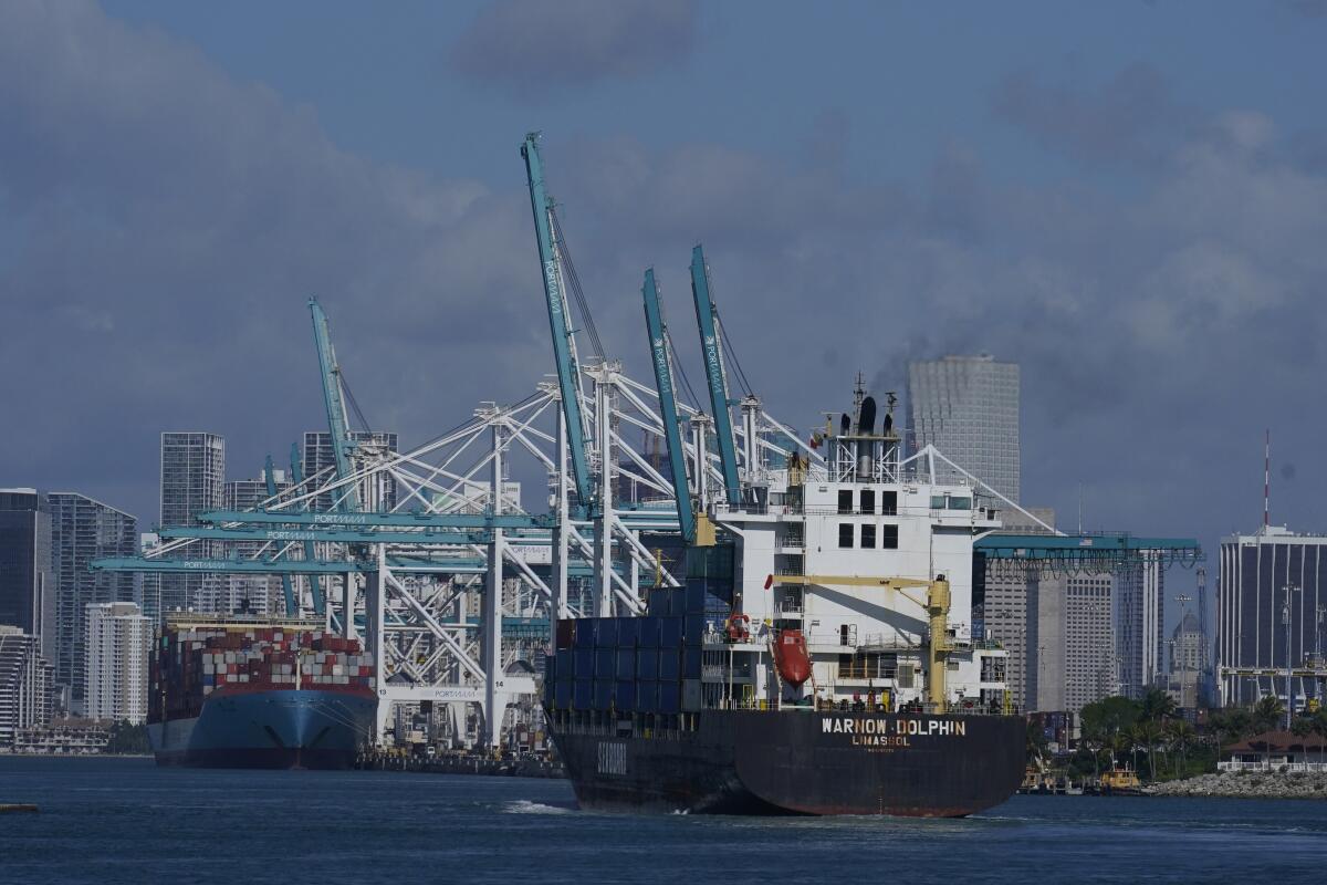 In this April 29, 2021 photo, The Warnow-Dolphin container ship enters PortMiami, in Miami Beach, Fla. Importers are contending with a perfect storm of supply trouble — rising prices, overwhelmed ports, a shortage of ships, trains, trucks — that is expected to last into 2022. (AP Photo/Marta Lavandier)