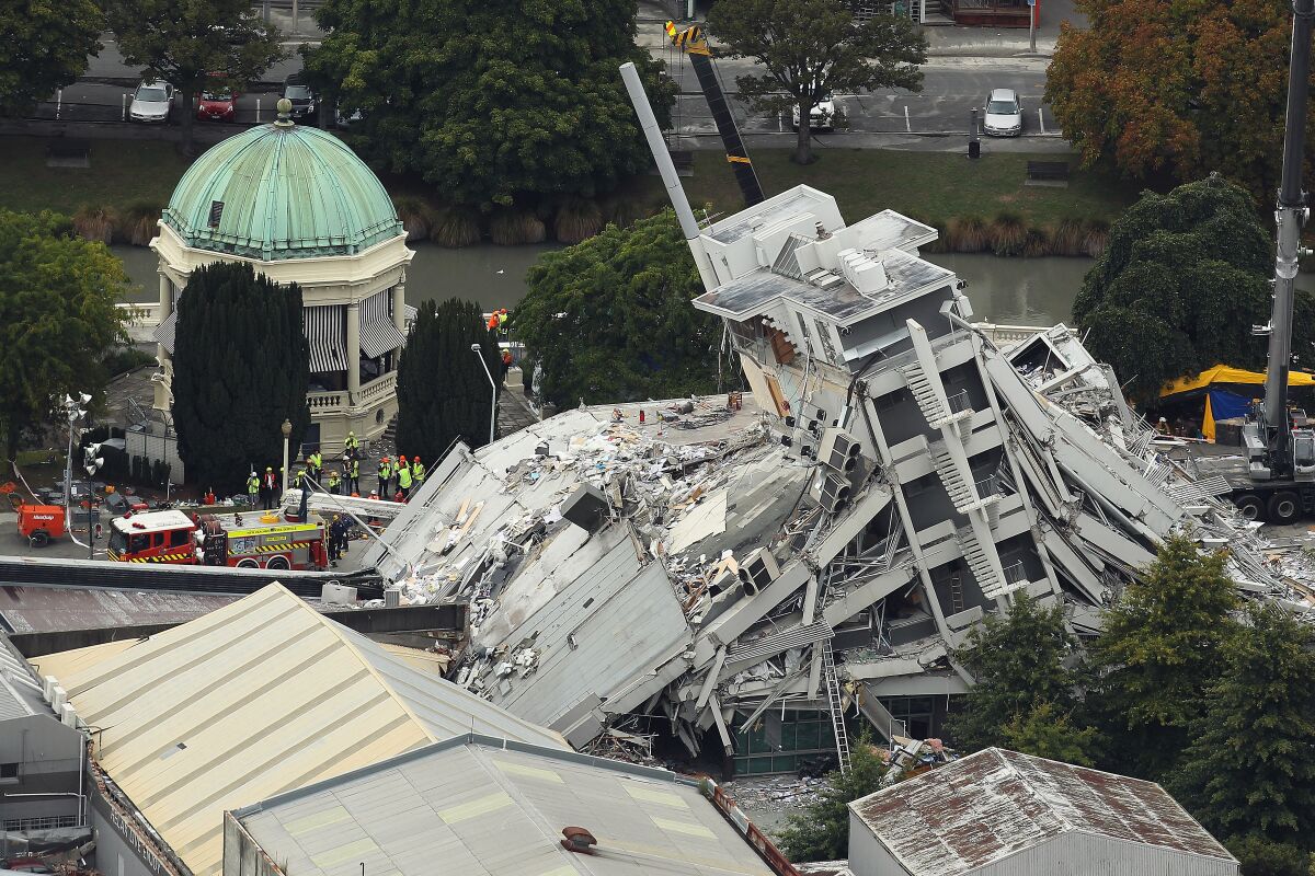 Rescue workers surround a collapsed building in New Zealand.