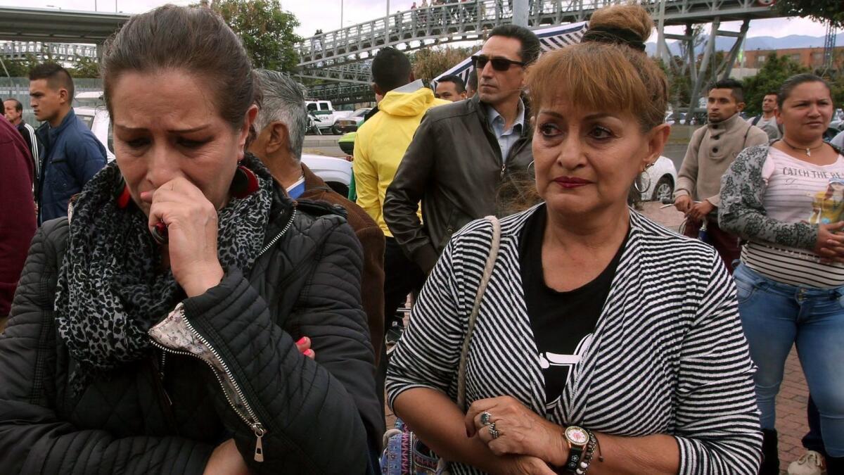 People wait for information about their relatives near a police academy car bomb explosion in Bogota, Colombia, on Thursday.