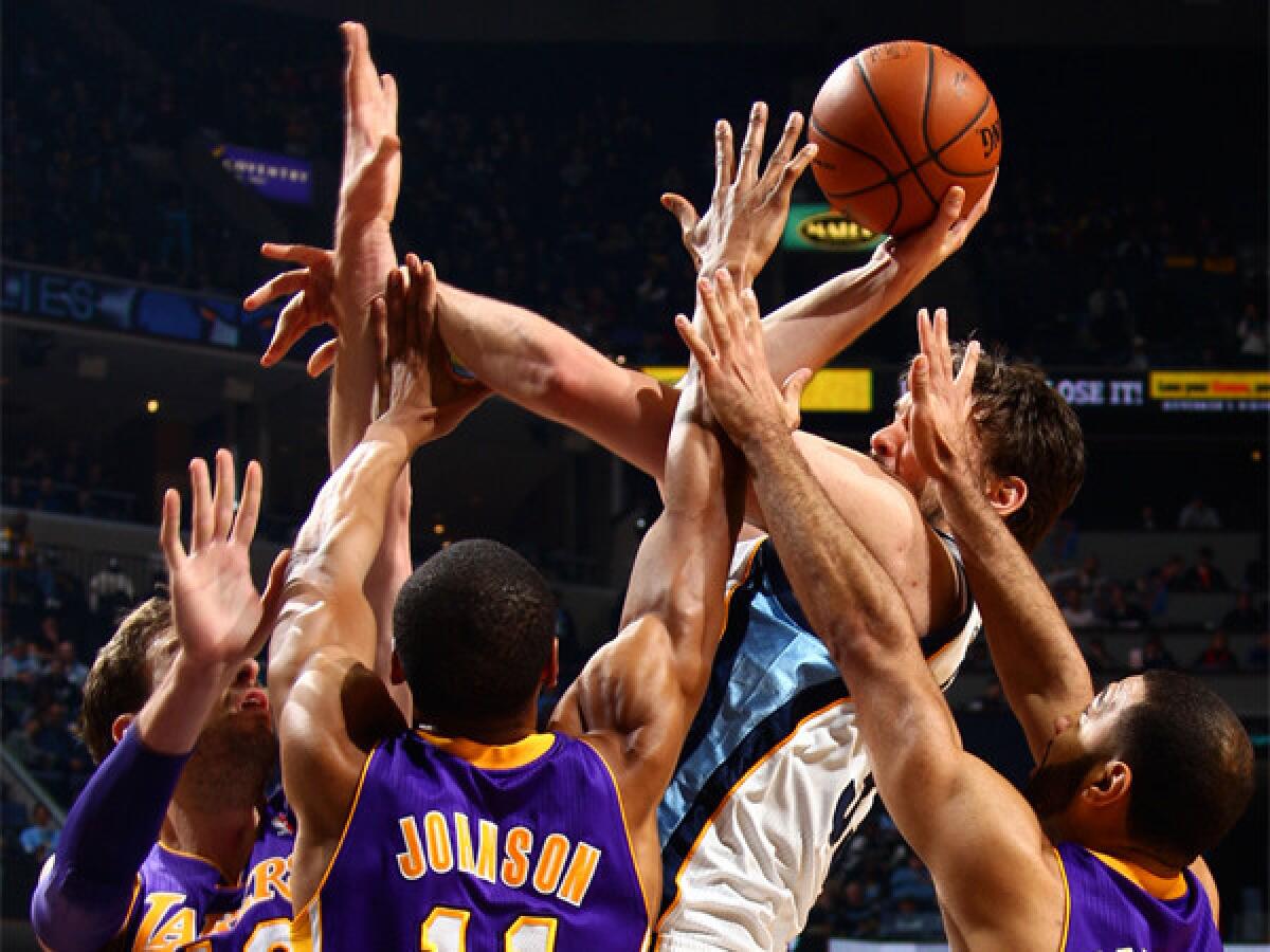 Memphis' Marc Gasol tries to create room against a triple-team by the Lakers' Pau Gasol, left, Wesley Johnson and Kendall Marshall on Feb. 26.