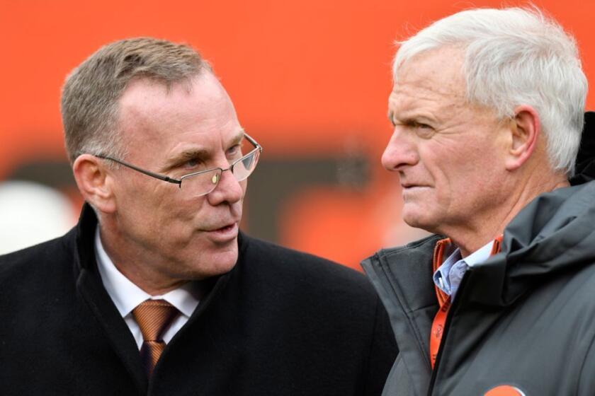 FILE - In this Sunday, Dec. 10, 2017 file photo, Cleveland Browns general manager John Dorsey, left, talks with owner Jimmy Haslam before an NFL football game against the Green Bay Packers in Cleveland. New Browns general manager John Dorsey played linebacker in the NFL. Turns out, he still hits hard. Dorsey, hired last week by owner Jimmy Haslam to fix his floundering franchise, harshly criticized the teamâs previous football head Sashi Brown on Thursday, Dec. 14, 2017 saying he failed to give coach Hue Jackson good players. (AP Photo/David Richard, File)
